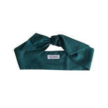 Load image into Gallery viewer, Dark green headband with a brand label on a white background