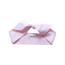 Load image into Gallery viewer, Light pink headband with a bow on a white background
