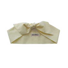 Load image into Gallery viewer, light yellow headband with a bow on a white background