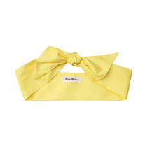 Load image into Gallery viewer, Yellow headband with a brand label on a white background