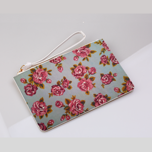 A stylish grey clutch bag adorned with a delicate pink rose pattern.