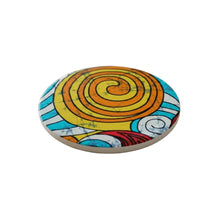 Load image into Gallery viewer, Colourful round ceramic coaster with Ankara spiral design on a white surface 