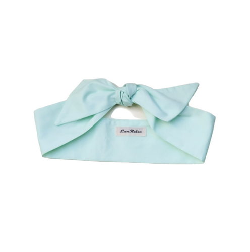 Mint green headband with a bow on a white background