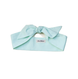Mint green headband with a bow on a white background