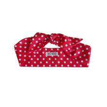 Load image into Gallery viewer, Red polka dot headband with a brand label on a white background