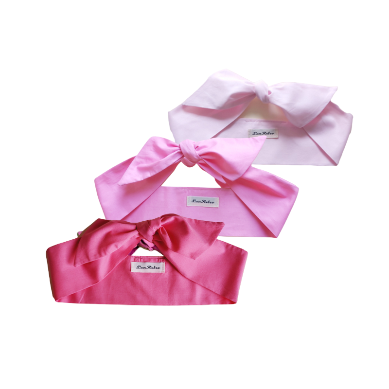 A set of three pink hair scarves displayed on a white background, with each scarf featuring a different shade of pink and a bow at the front.