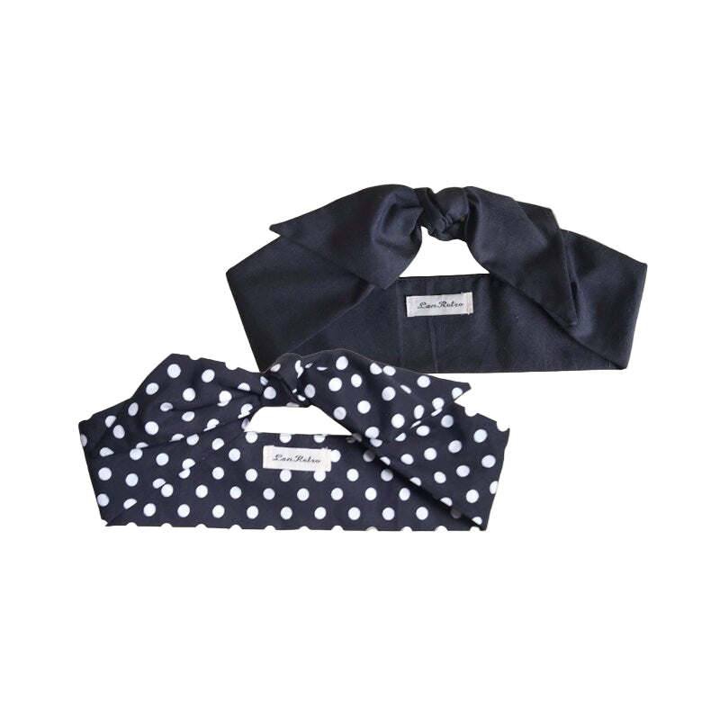 Two hair scarves laid out on a white surface, one solid black and the other with a black and white polka dot pattern.