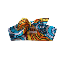 Load image into Gallery viewer, A colourful Ankara cotton hair scarf displayed on a neutral background, featuring blue, yellow, and other vibrant hues in a patterned design.