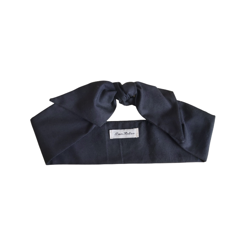 A folded black cotton hair scarf with a brand tag visible, displayed against a white background.