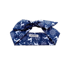 Load image into Gallery viewer, A navy blue and white reindeer print hair scarf tied in a knot, displayed on a neutral background.