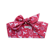 Load image into Gallery viewer, A red and white reindeer print hair scarf laid flat on a surface.