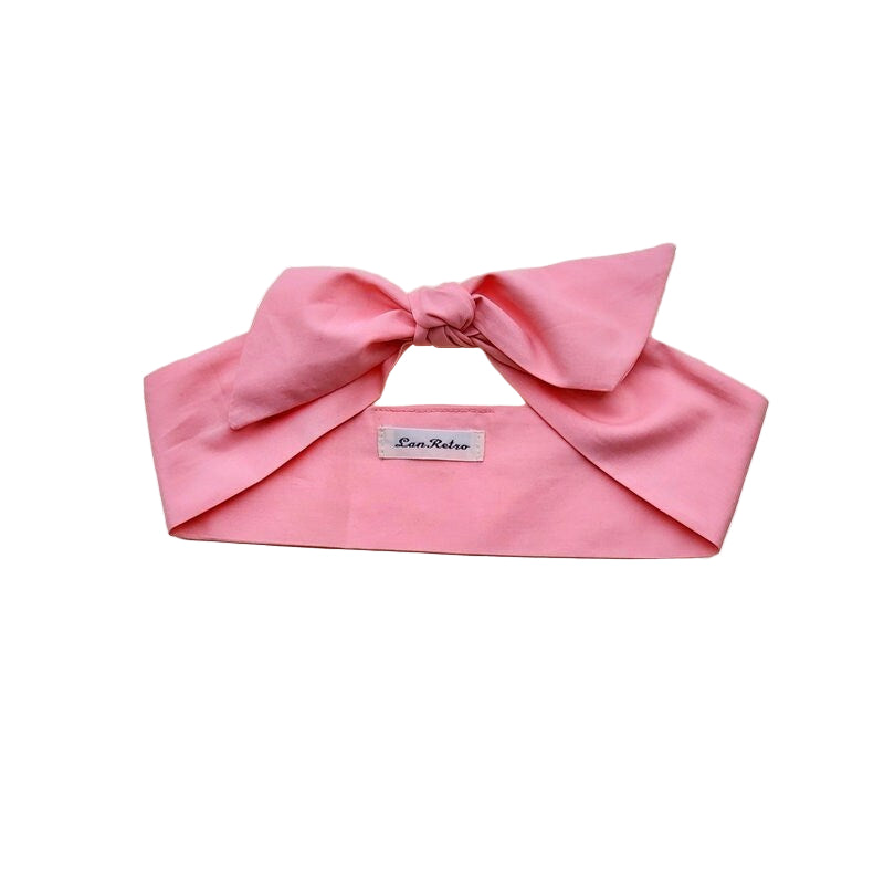 A salmon pink 100% cotton hair scarf on a white background.