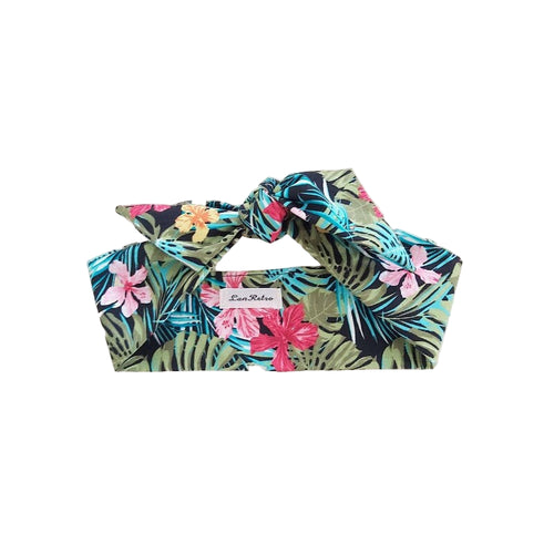 A multicolored cotton tropical print hair scarf tied in a knot, displayed on a neutral background.