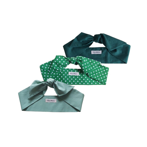 A set of three green colored hair scarves, with one solid green, one with a green and white polka dot pattern, and one in a light shade of green, all displayed on a white background.