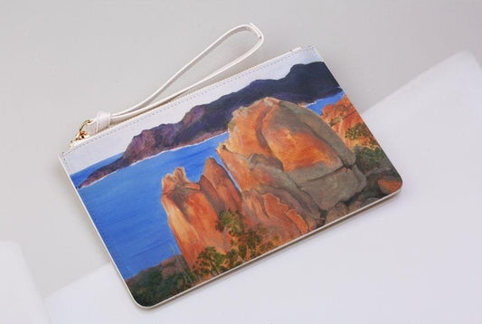 Mountainside illustrated clutch bag on a light grey background